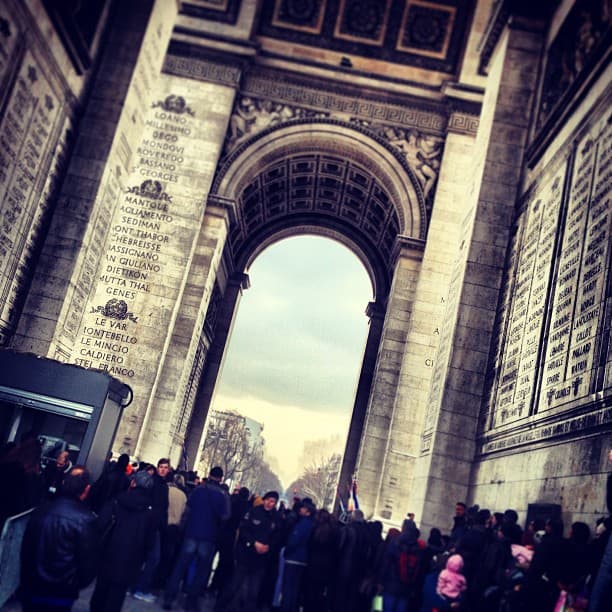 Arc de Triomphe with people crowded underneat in Paris