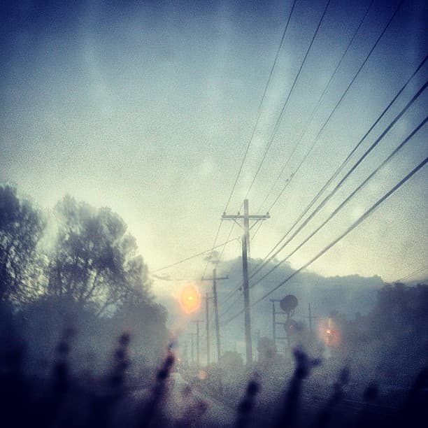 Foggy morning along a railroad track and electrical lines