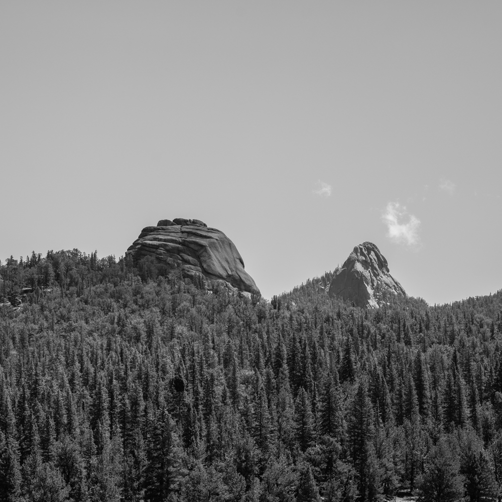 2 round rock structures extend out of a Colorado mountain confer landscape